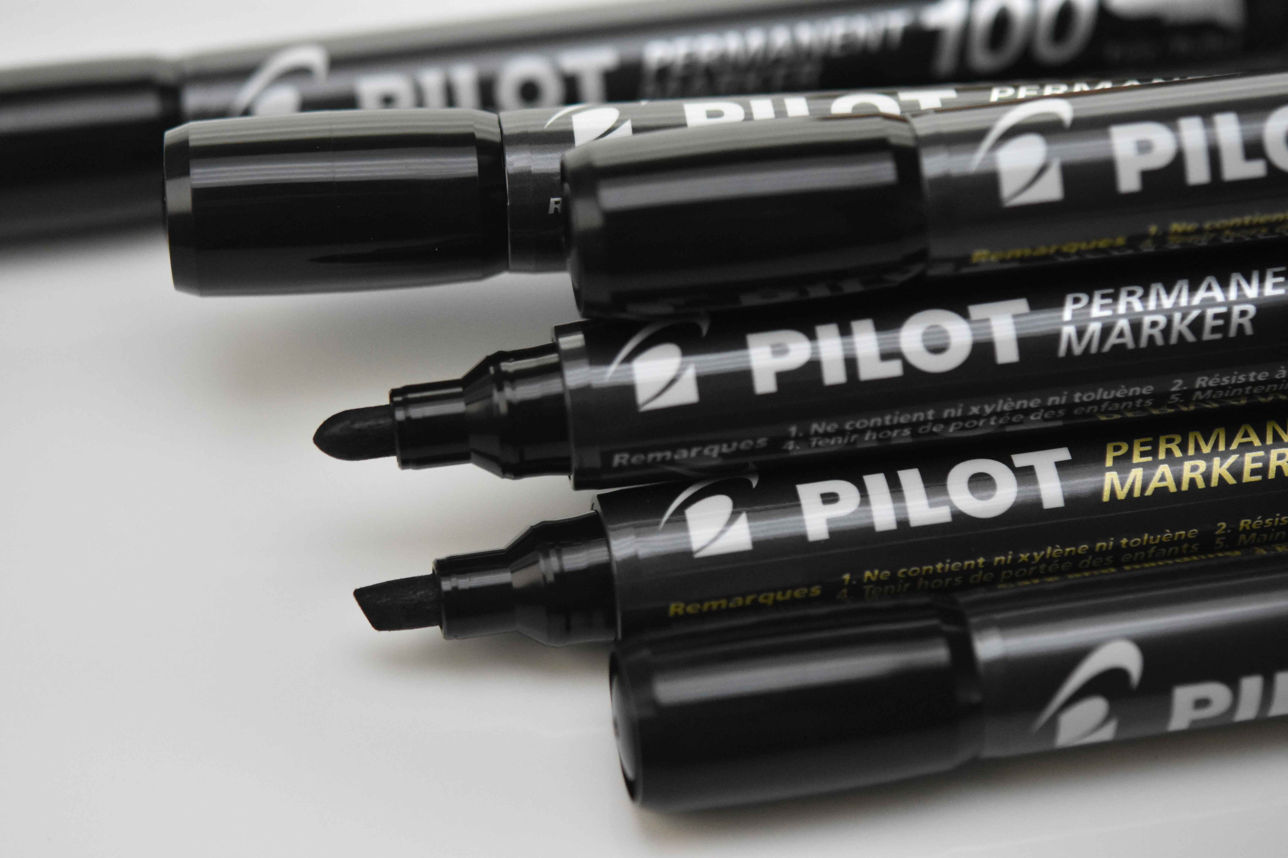 A close up of PILOT SCA-400 and 100 Permanent Markers, showcasing the bullet and chisel shaped tips. 