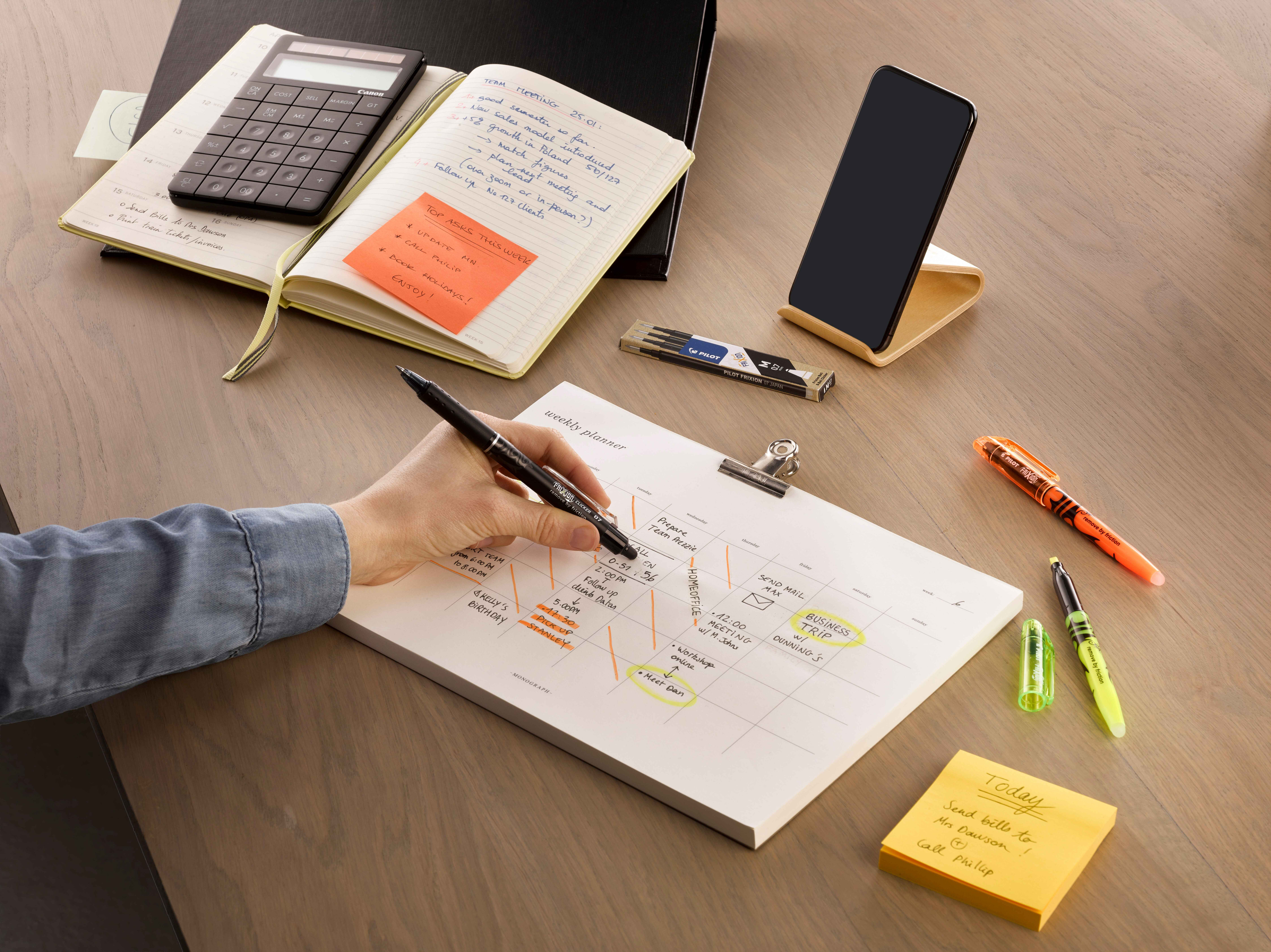 An event planner using an erasable pen for her notes to allow for adjustments